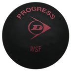 Close-up of Dunlop Progress squash ball, 6% larger, 20% longer hang time, highlighting N-1SR tech and textured rubber.
